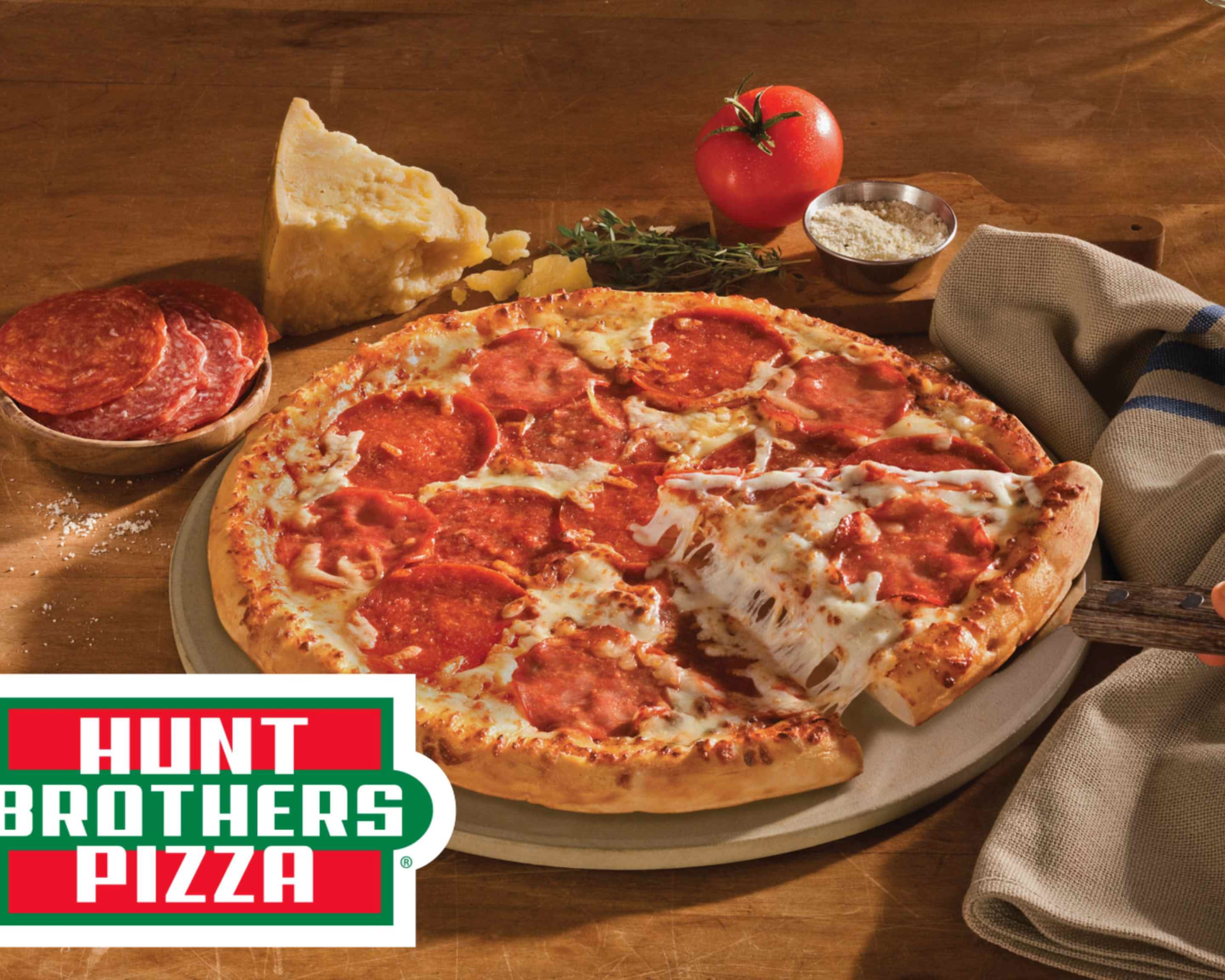 Hunt Brothers pepperoni pizza with a slice being lifted